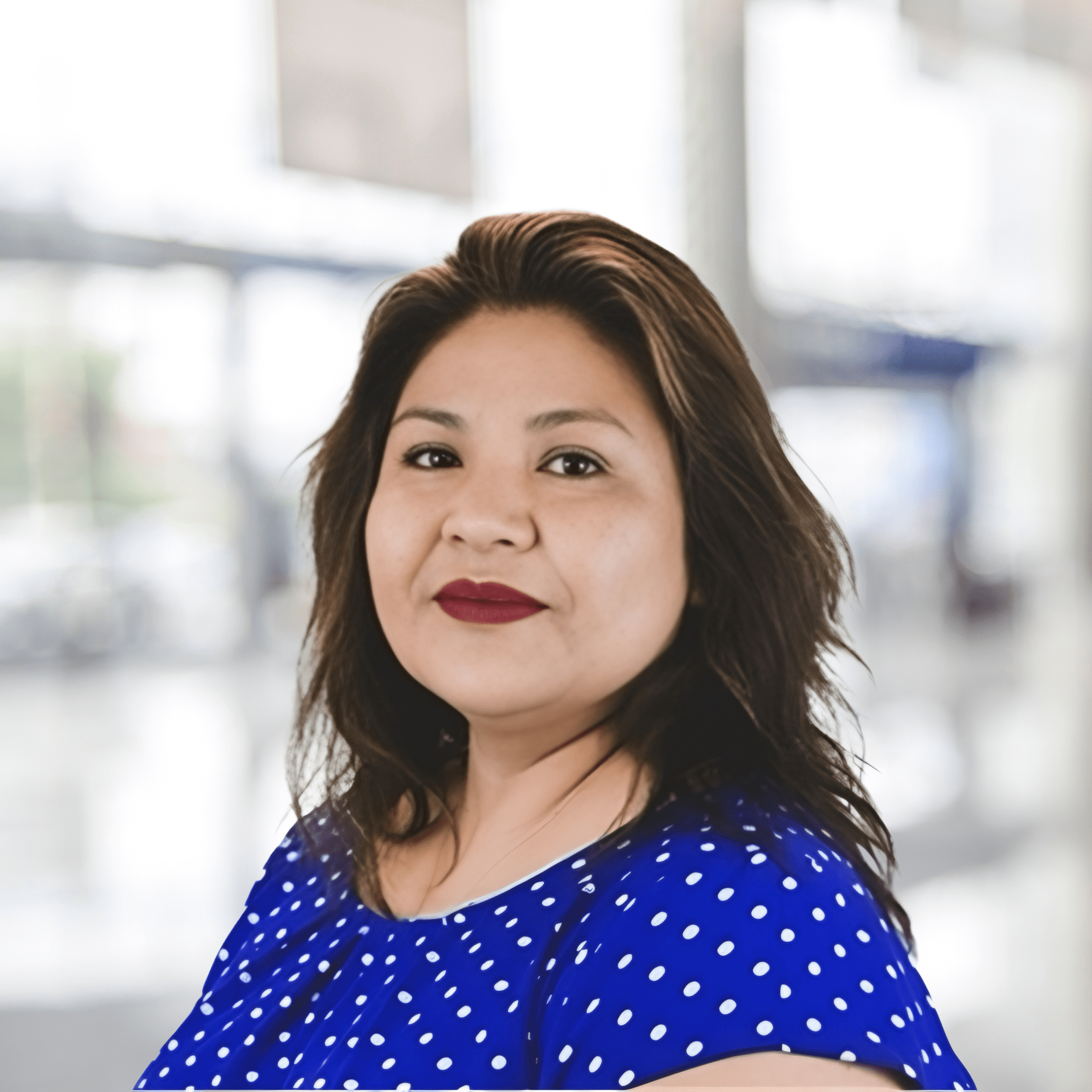 Maria Cruz, Payroll Manager, smiling confidently in a professional office setting
