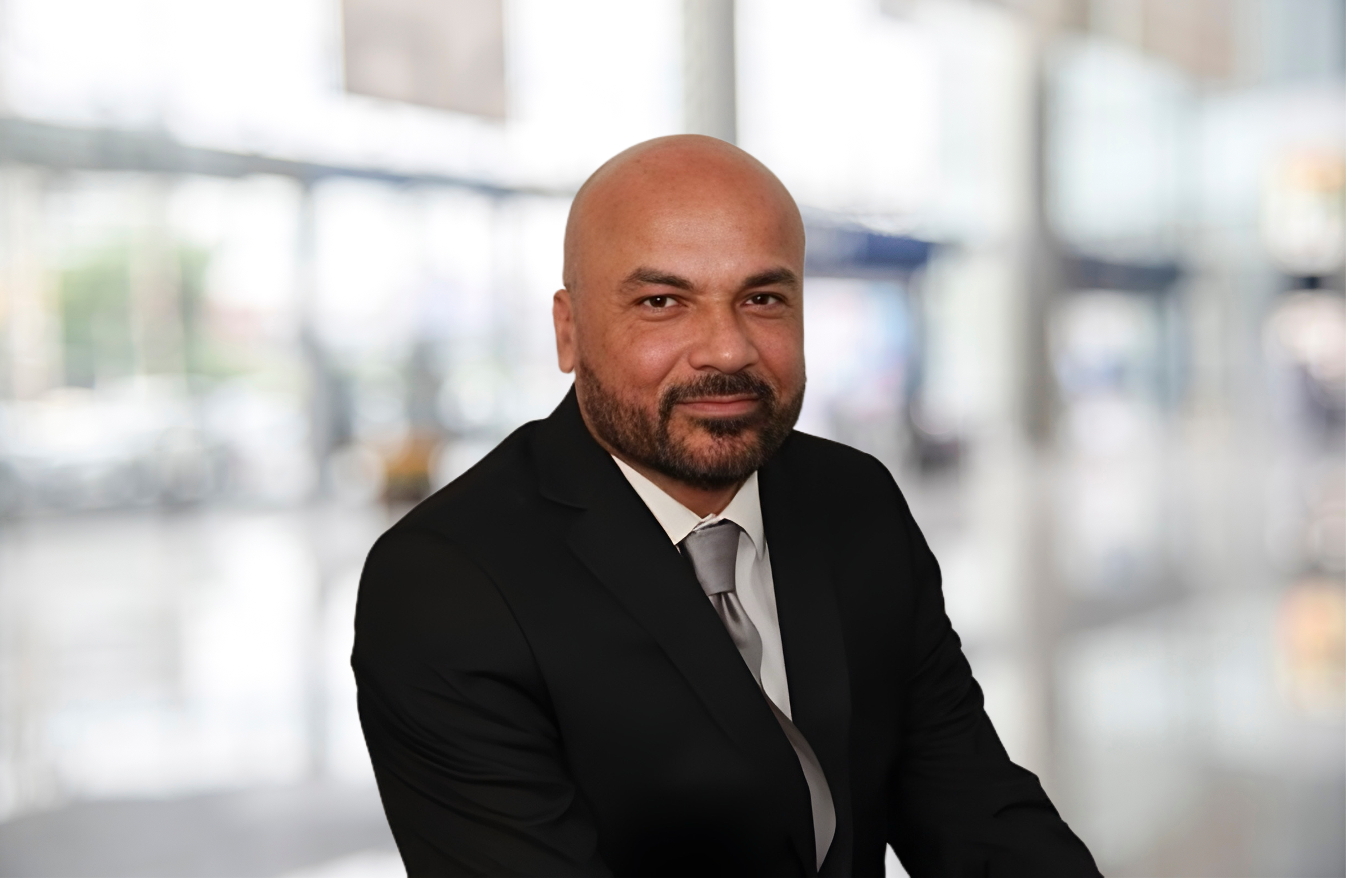 Richard Nieves, Operations Manager, standing confidently in a warehouse setting with arms crossed